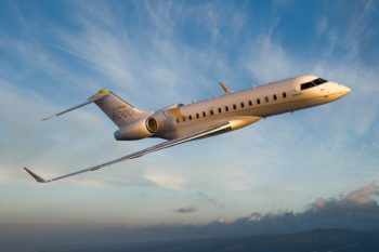 Bloom Business Jets’ Bombardier Global 6000 flying through blue sky.
